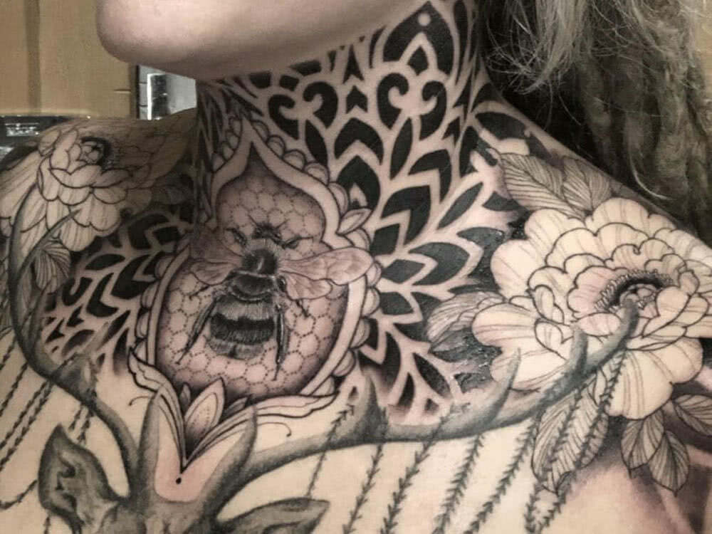 neck and throat tattoo for women with ornamental design